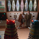 Peter Cushing's Dr. Who, as well as his companions Susan and Ian, are menaced by the Daleks.